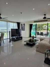 2 Bedroom Condo for Sale at The Park Jomtien spacious living room with TV and balcony access