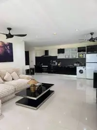 2 Bedroom Condo for Sale at The Park Jomtien open-plan living area with sofa and kitchen view