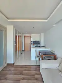 1 Bedroom Condo for Rent at The Peak Towers hallway view of kitchen, dining table, and entrance door