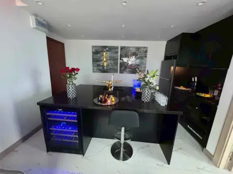 1 Bedroom Condo for Sale & Rent at The Peak Towers kitchen counter with flowers and built-in wine fridge