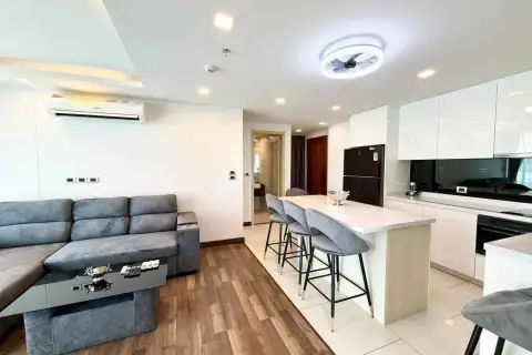 2 Bedroom Condo for Rent at The Peak Towers open-plan kitchen with white cabinetry and bar seating