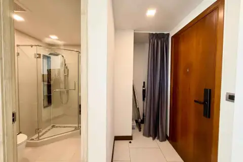 2 Bedroom Condo for Rent at The Peak Towers hallway with glass shower room and wooden entry door