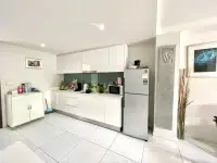 1 Bedroom Condo for Sale at The Place Pratumnak white fitted kitchen with fridge and overhead cabinets