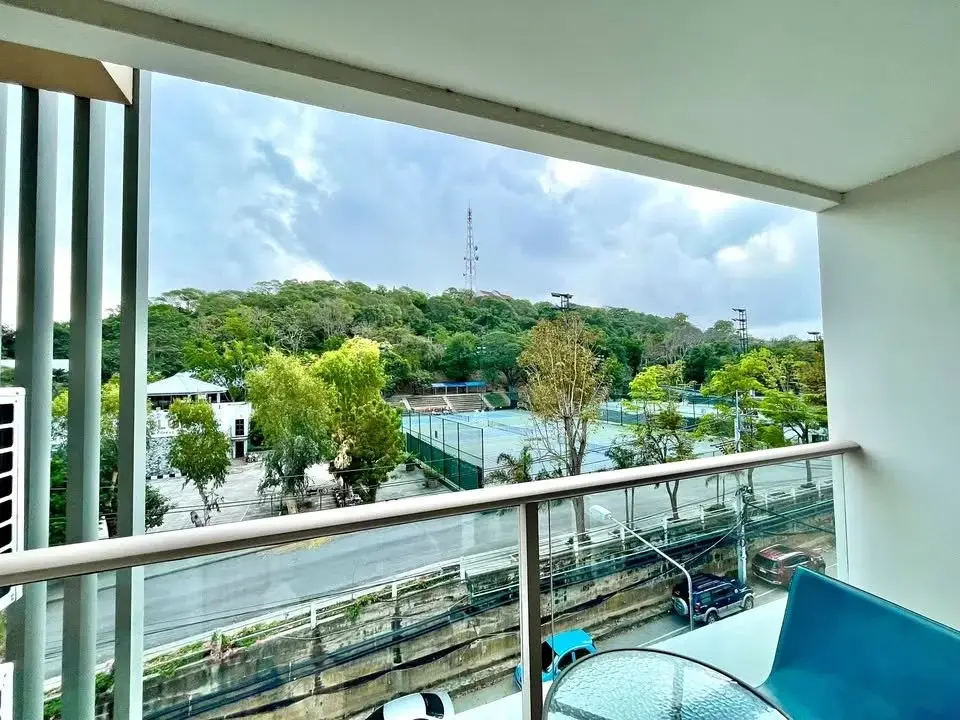 1 Bedroom Condo for Sale at The Place Pratumnak balcony view overlooking tennis courts and green hillside