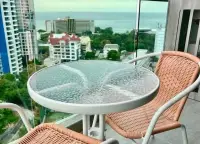 2 Bedroom Condo for Sale at The Point Pratumnak balcony seating area overlooking city and sea