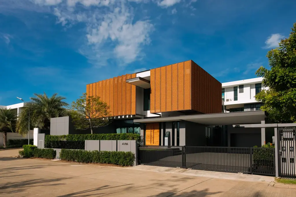 3 Bedroom House for Sale at The Prospect modern two-story facade with wood slat cladding and gated entrance in Pattaya