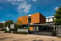 3 Bedroom House for Sale at The Prospect modern two-story facade with wood slat cladding and gated entrance in Pattaya