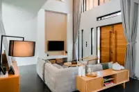3 Bedroom House for Sale at The Prospect double-height living room with sectional sofa and wooden entry doors