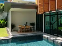 3 Bedroom House for Sale at The Prospect covered poolside dining nook with wooden table and tropical landscaping