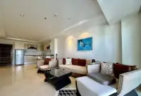 2 Bedroom Condo for Sale at The Residence Jomtien living area with blue artwork and woven furniture