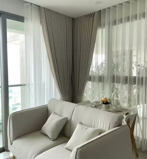 1 Bedroom Condo for Rent at The Riviera Jomtien lounge area with sofa, rug, TV and balcony city view