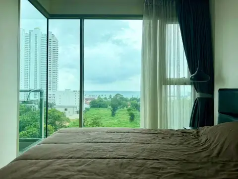 1 Bedroom Condo for Rent at The Riviera Jomtien bedroom with floor-to-ceiling windows and ocean view