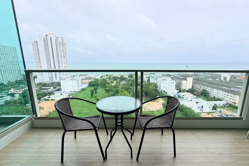 2 Bedroom Condo for Rent at The Riviera Jomtien balcony with rattan chairs, table and sea view