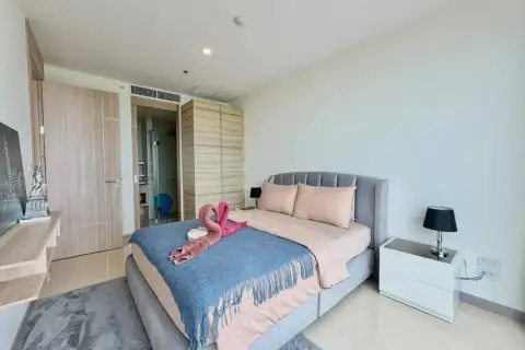 2 Bedroom Condo for Rent at The Riviera Jomtien bedroom with wardrobe, nightstands and ensuite bathroom