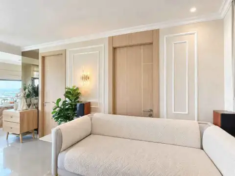 2 Bedroom Condo for Rent at The Riviera Jomtien living area with cozy sofa and decorative wall molding details
