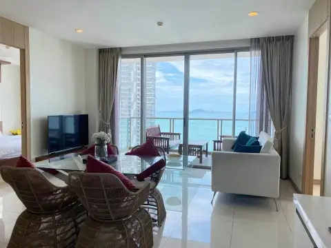 2 Bedroom Condo for Sale at The Riviera Jomtien open living room with sea view through sliding doors