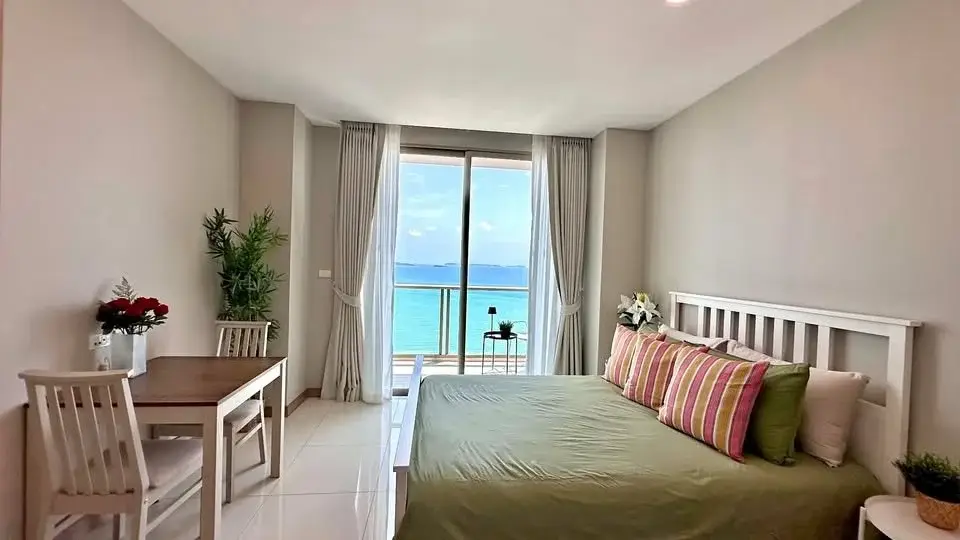 Studio Condo for Sale at The Riviera Jomtien bedroom with balcony door and ocean view