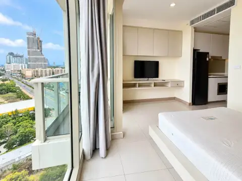 Studio Condo for Sale at The Riviera Jomtien balcony view overlooking city skyline and high-rise construction