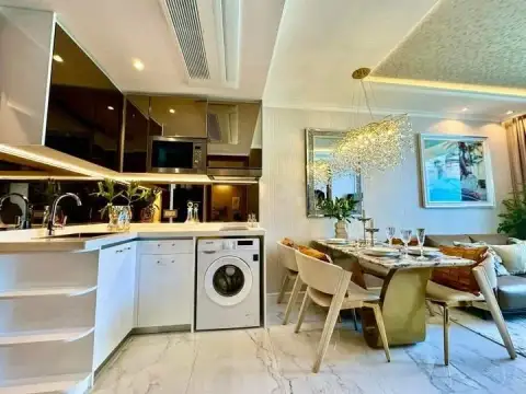 1 Bedroom Condo for Sale at The Riviera Malibu open-plan kitchen with marble counters and dining table