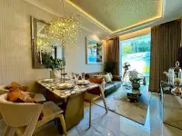 1 Bedroom Condo for Sale at The Riviera Malibu dining area with crystal chandelier and living room with balcony view