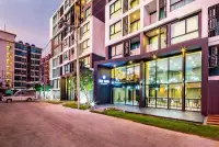 1 Bedroom Condo for Sale at The Rizin Hotel & Residences building exterior and entrance at dusk