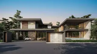 The Scenevanar modern condo complex entrance with a security gate, sleek architecture, and dense green landscaping.