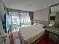 2 Bedroom Condo for Sale at The Senate Residences master bedroom with sheer curtains, wall-mounted TV and mirrored vanity