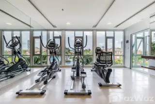 The Trust Condo South Pattaya fitness center with elliptical machines and large windows overlooking the pool