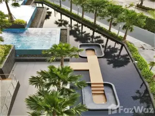 The Trust Condo South Pattaya rooftop reflecting pool with wooden sun deck lined by palm trees