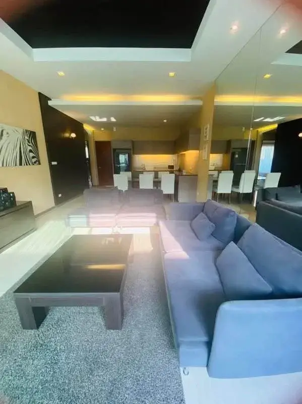 3 Bedroom House for Rent at The Ville Jomtien open-plan living room with sectional sofa and dining area