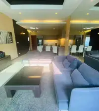 3 Bedroom House for Rent at The Ville Jomtien open-plan lounge with sofas, coffee table and dining area