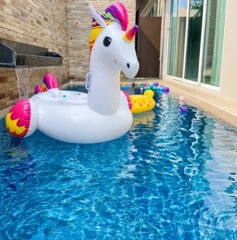 3 Bedroom House for Rent at The Ville Jomtien outdoor pool with colorful unicorn and giraffe inflatable floats