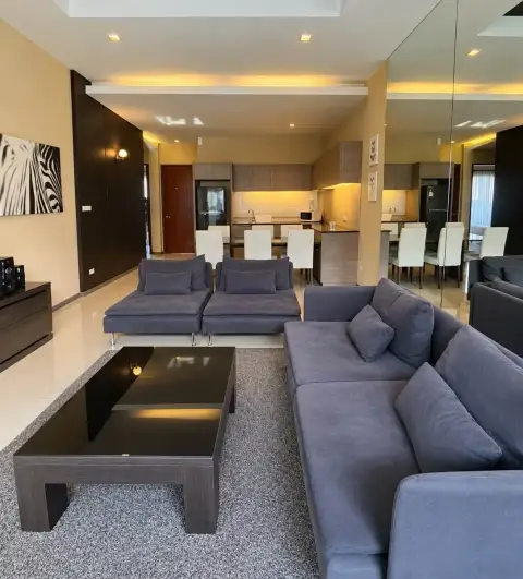 3 Bedroom House for Rent at The Ville Jomtien open-plan living area with sofas, dining table, and kitchen
