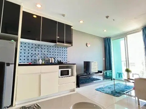 1 Bedroom Condo for Sale at The Vision open kitchen with black cabinets, microwave and living area view