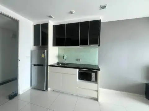 1 Bedroom Condo for Sale at The Vision compact kitchenette with fridge, black countertop and glass backsplash