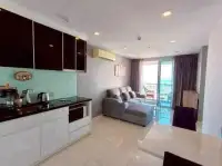 1 Bedroom Condo for Sale at The Vision open-plan kitchen with black cabinetry and living area balcony view