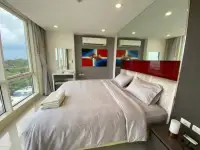 1 Bedroom Condo for Sale at The Vision bedroom with king bed, city view windows, and wall art
