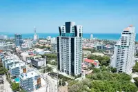 1 Bedroom Condo for Sale at The Vision aerial view of high-rise tower amid Pattaya cityscape and coastline
