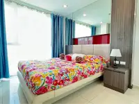 1 Bedroom Condo for Sale at The Vision bedroom with floral bedding, mirrored wall and bedside lamp