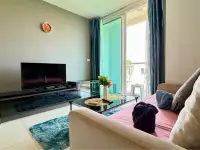 1 Bedroom Condo for Sale at The Vision living room with sofa, flat-screen TV and balcony access