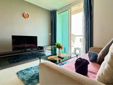 1 Bedroom Condo for Sale at The Vision living room with sofa, flat-screen TV and balcony access