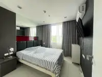 1 Bedroom Condo for Sale at The Vision bedroom with upholstered headboard, mirrored wall, and curtains