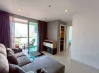 1 Bedroom Condo for Sale at The Vision living room with gray sofa, glass coffee table, and balcony access