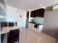 1 Bedroom Condo for Sale at The Vision dining area and kitchenette with dark cabinets and tile flooring