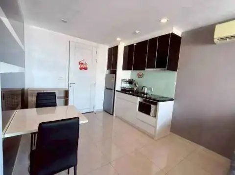 1 Bedroom Condo for Sale at The Vision dining area and kitchenette with dark cabinets and tile flooring