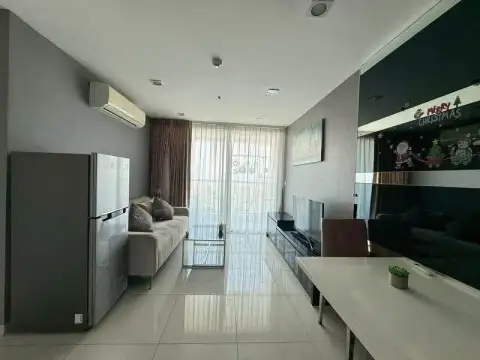 1 Bedroom Condo for Sale at The Vision living area with balcony window, sofa and mirrored wall with holiday decor
