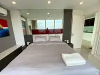 1 Bedroom Condo for Sale at The Vision bedroom reflected in mirror with city skyline view and kitchen access