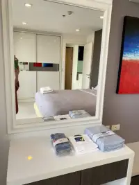 1 Bedroom Condo for Sale at The Vision dressing table with mirror and folded towels beside bedroom