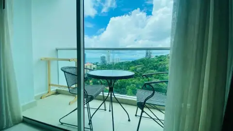 1 Bedroom Condo for Rent at The Vision private balcony with rattan table, chairs, and panoramic sky view