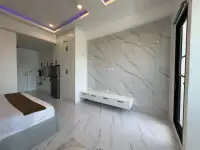 Studio Condo for Sale at Thepthip Mansion Condominium marble feature wall with built-in TV console and kitchenette nook